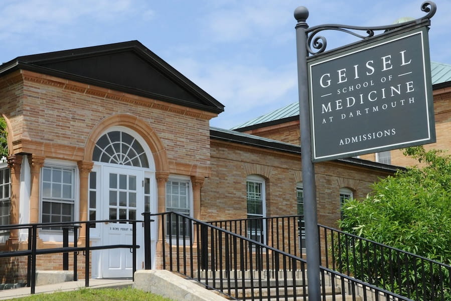 medical residents at Dartmouth Geisel Match Day ceremony opening envelopes while considering disability insurance timing and eligibility during residency transition