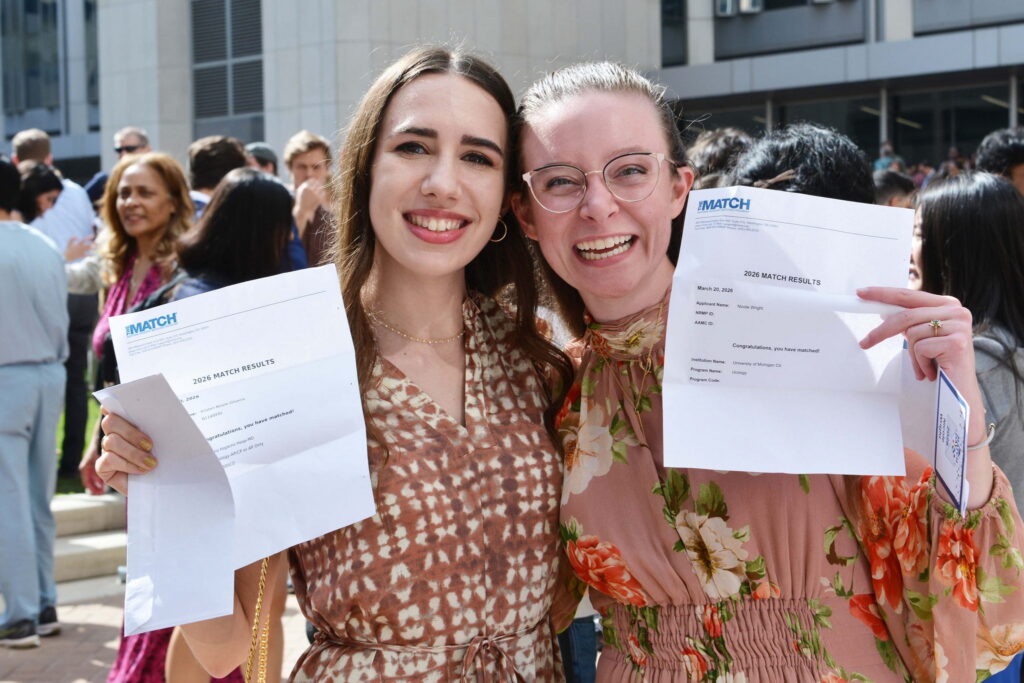 Two Baylor College of Medicine students smiling and holding 2026 Match Day results letters during residency placement celebration