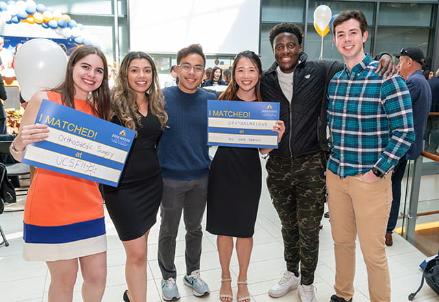 ohns Hopkins School of Medicine students celebrating Match Day 2025 holding I Matched signs showing placements in orthopedic surgery at UCSF and ophthalmology at UC San Diego. Photo courtesy of Johns Hopkins Medicine.